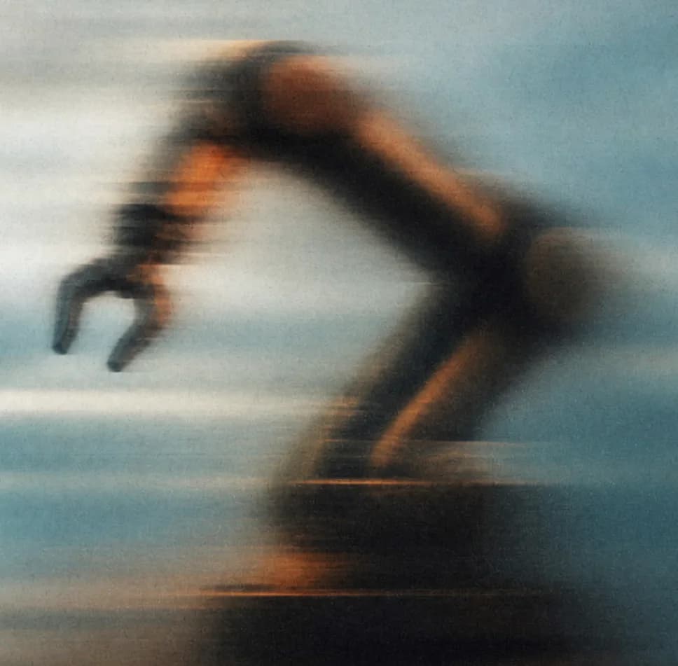 Industrial robot arm sweeping across the frame, in motion blur